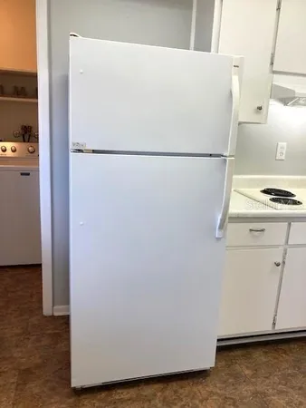 a white refrigerator freezer sitting in a kitchen