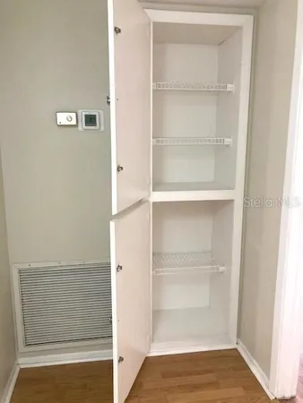 a view of walk in closet with empty racks
