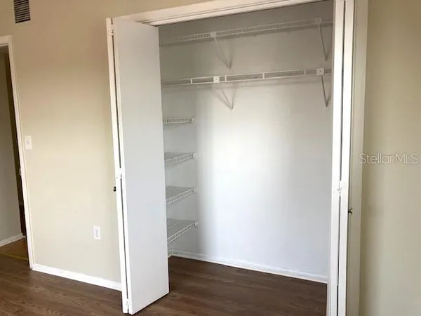 a view of a room with wooden floor