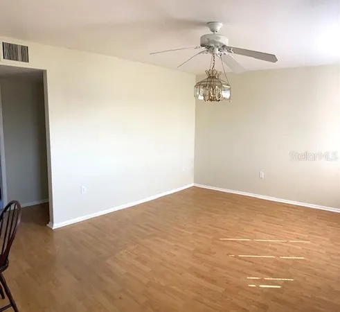 a view of a room with a hanging light and kitchen