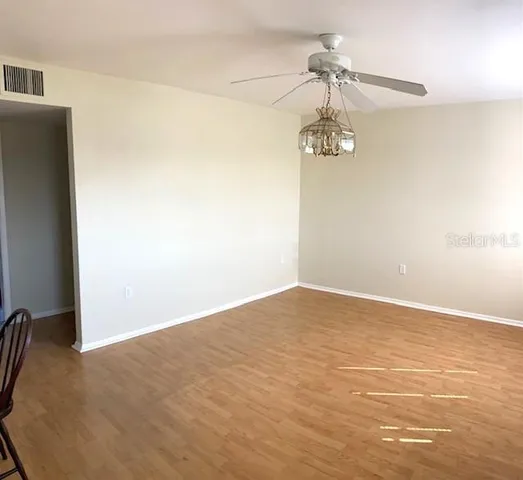 a view of a room with a hanging light and kitchen