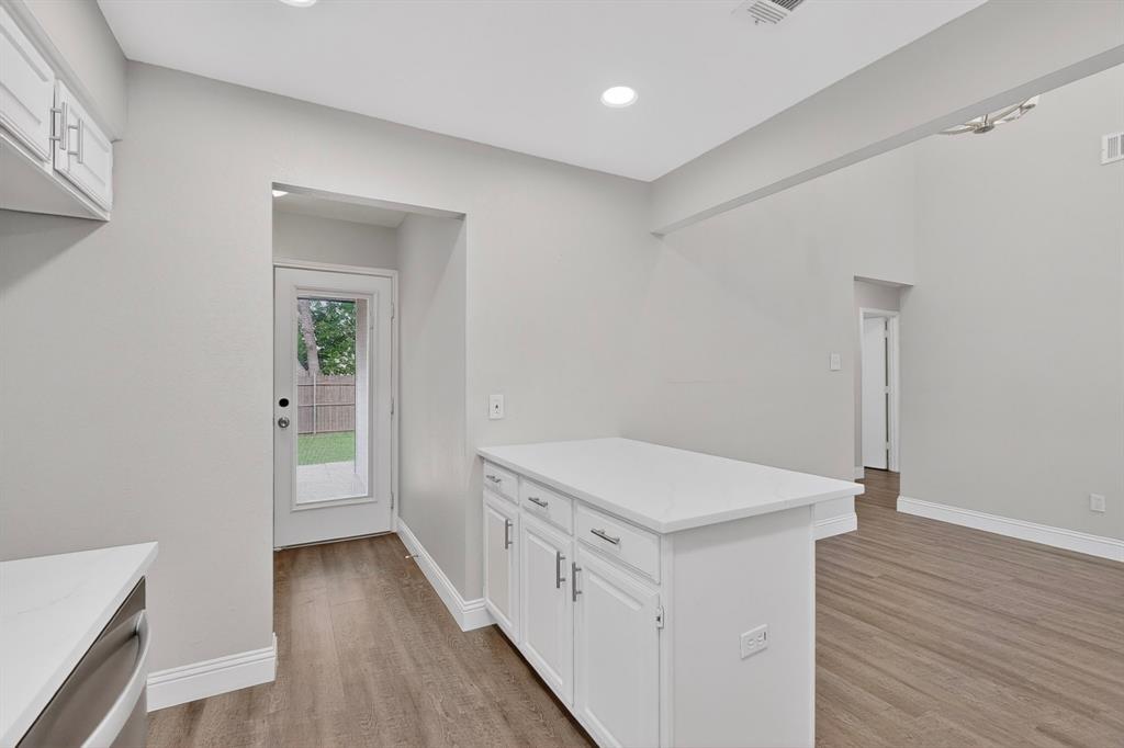7729 Misty Ridge Drive North Fort Worth, TX 76137 - Photo 9 of 30 a hallway with white cabinets and wooden floor