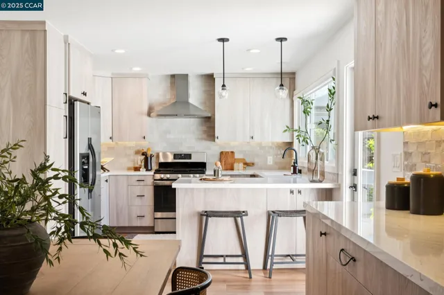 a kitchen with a table chairs stove and cabinets