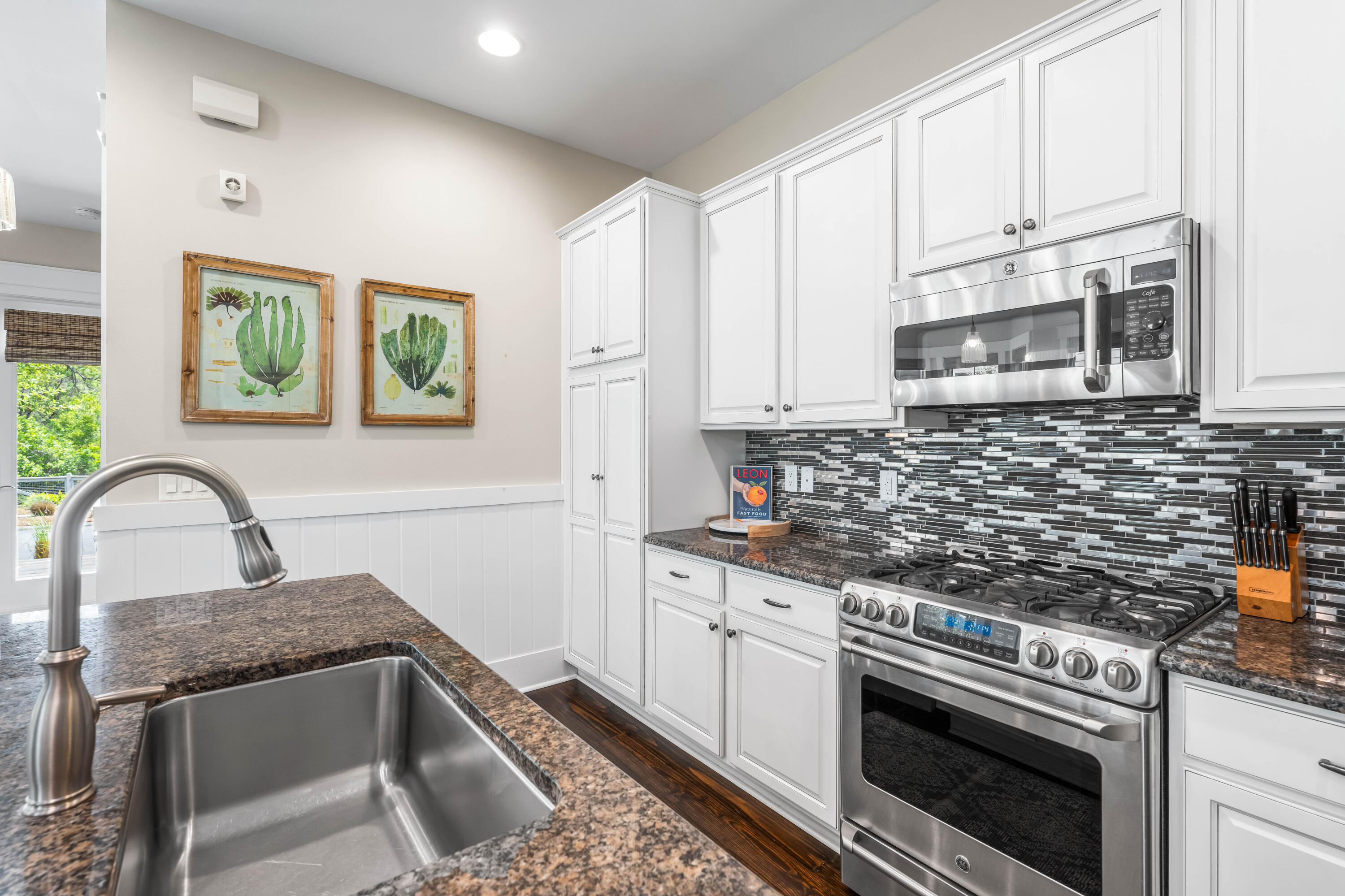 979 Sandgrass Boulevard Santa Rosa Beach, FL 32459 - Photo 10 of 72 a kitchen with stainless steel appliances granite countertop a stove a sink and a microwave