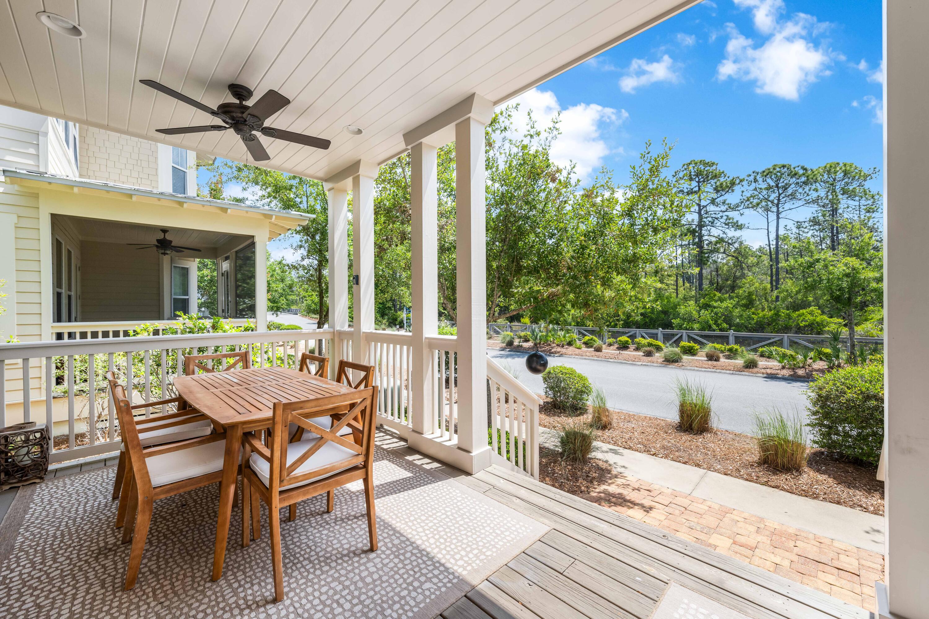 979 Sandgrass Boulevard Santa Rosa Beach, FL 32459 - Photo 45 of 72 a view of a patio with a table chairs and a potted plant