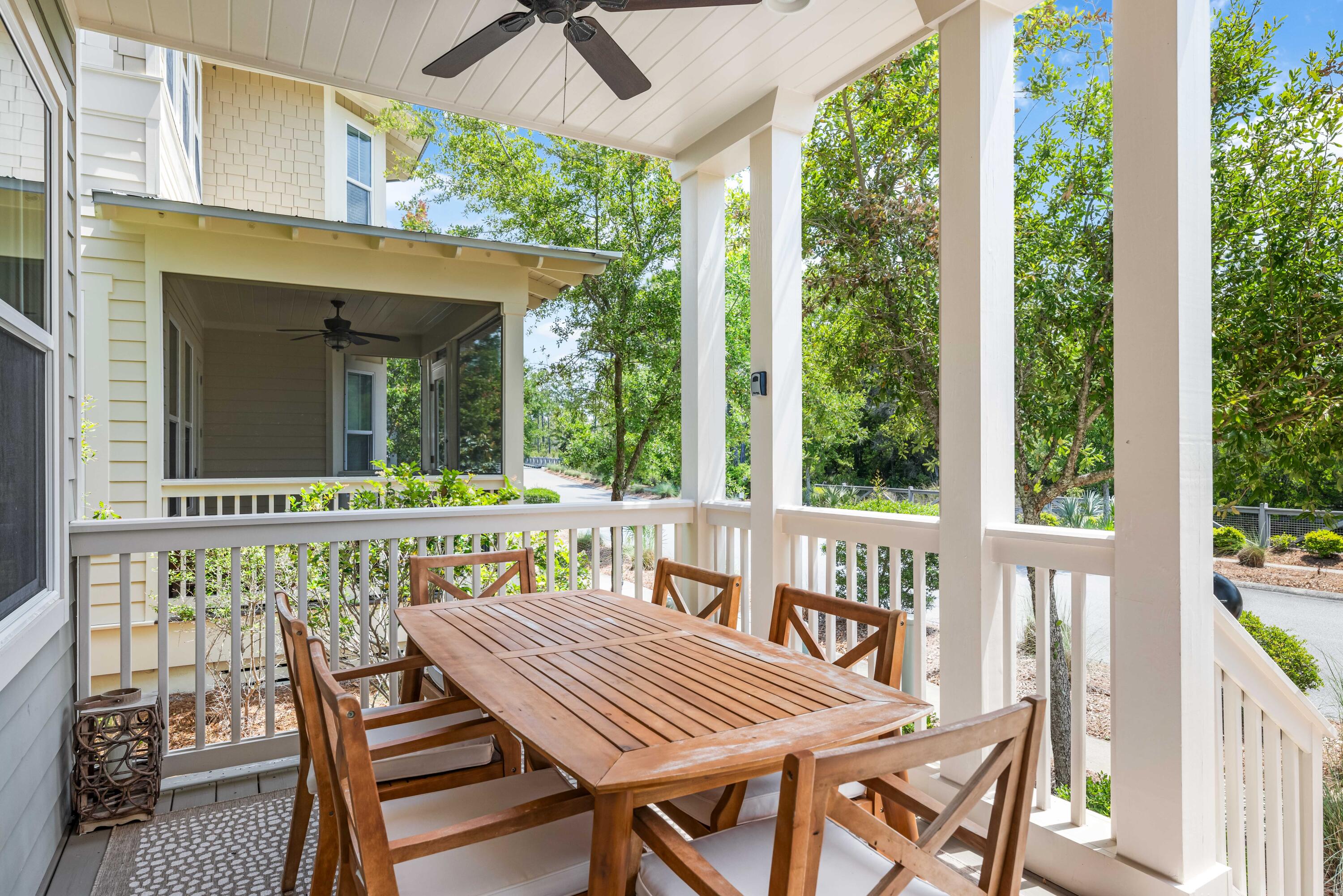 979 Sandgrass Boulevard Santa Rosa Beach, FL 32459 - Photo 46 of 72 a view of a patio with table and chairs and wooden floor
