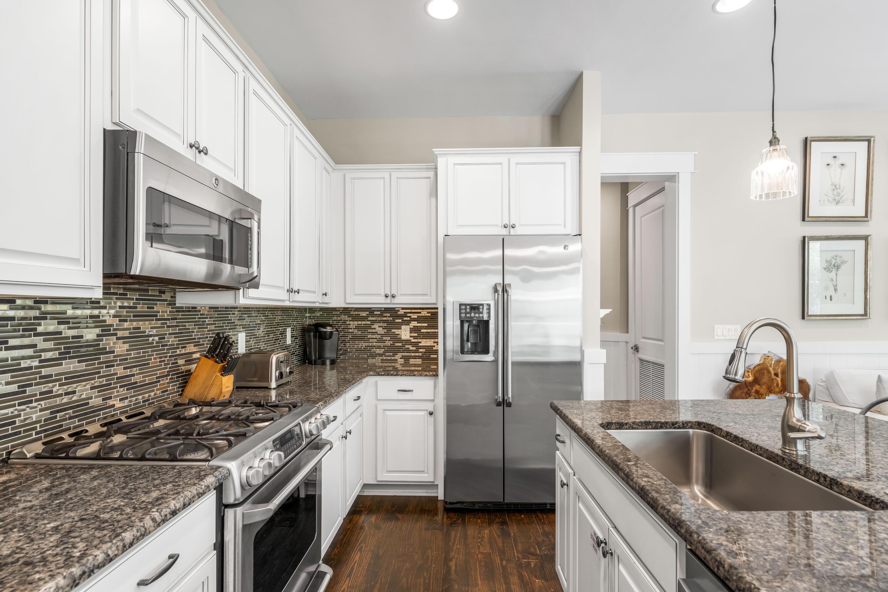 979 Sandgrass Boulevard Santa Rosa Beach, FL 32459 - Photo 7 of 72 a kitchen with granite countertop a sink stainless steel appliances and cabinets