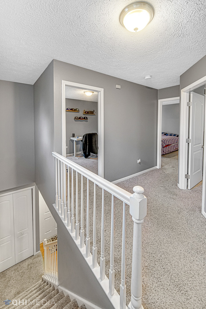 3208 Old Castle Road Joliet, IL 60431 - Photo 15 of 19 a view of a hallway with wooden floor and windows