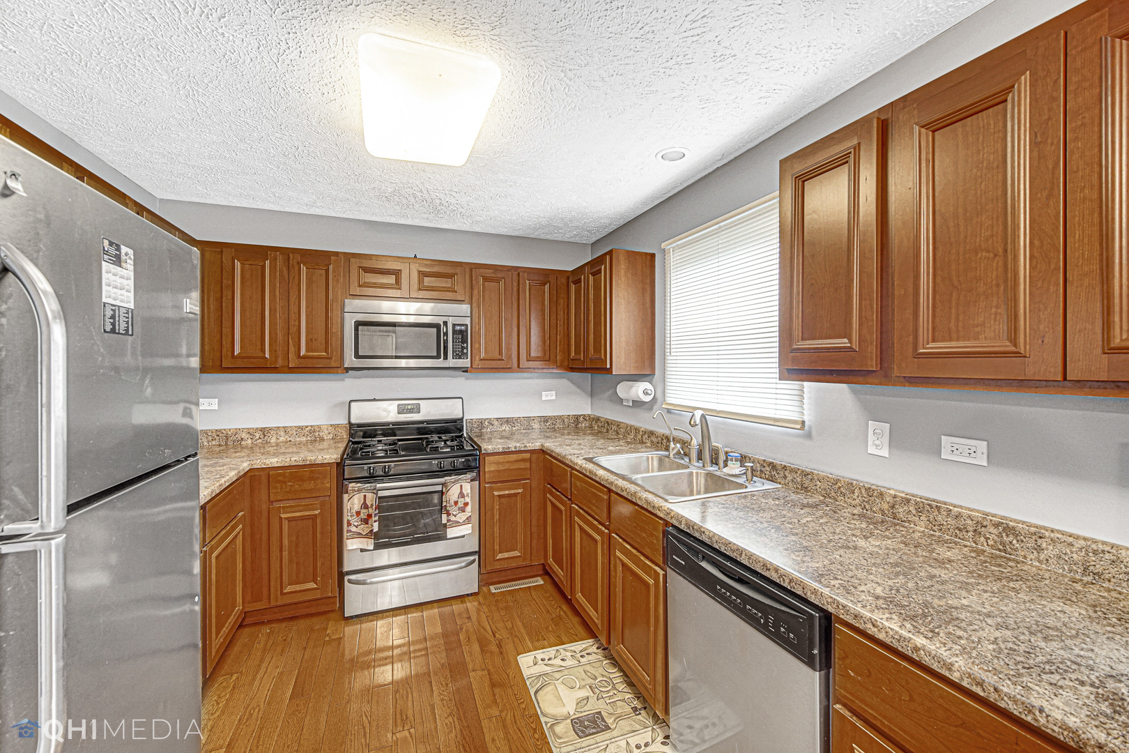 3208 Old Castle Road Joliet, IL 60431 - Photo 5 of 19 a kitchen with stainless steel appliances granite countertop wooden cabinets a stove top oven a sink and dishwasher