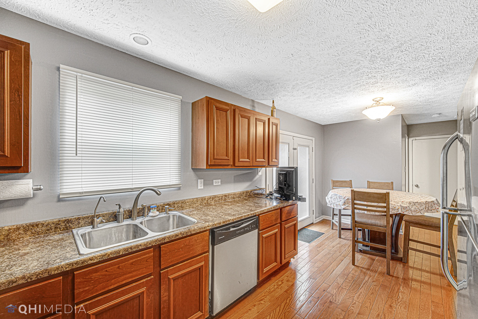 3208 Old Castle Road Joliet, IL 60431 - Photo 6 of 19 a kitchen with a sink stove and wooden cabinets
