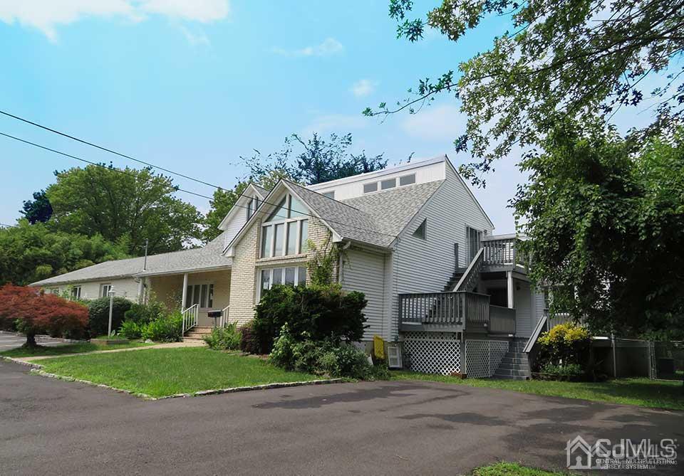 1818 Oak Tree Road Edison, NJ 08820 - Photo 1 of 25 a white house that has a tree in front of it