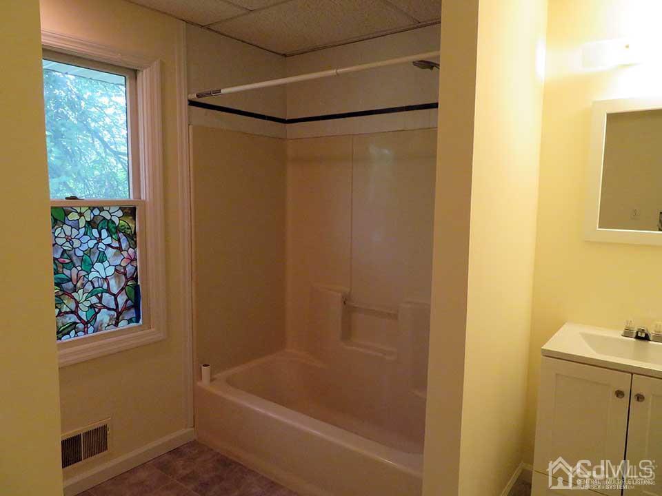 1818 Oak Tree Road Edison, NJ 08820 - Photo 11 of 25 a bathroom with a tub and shower