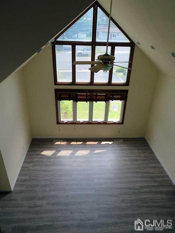 1818 Oak Tree Road Edison, NJ 08820 - Photo 14 of 25 an empty room with wooden floor and windows