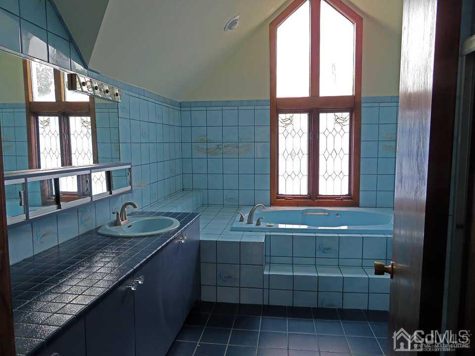 1818 Oak Tree Road Edison, NJ 08820 - Photo 19 of 25 a bathroom with a granite countertop sink a window and shower