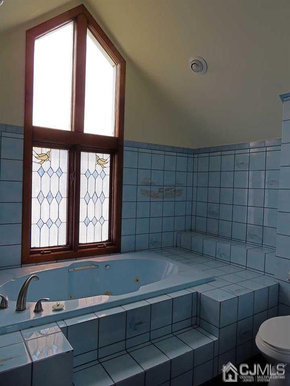 1818 Oak Tree Road Edison, NJ 08820 - Photo 20 of 25 a bathroom with a bathtub and next to a window