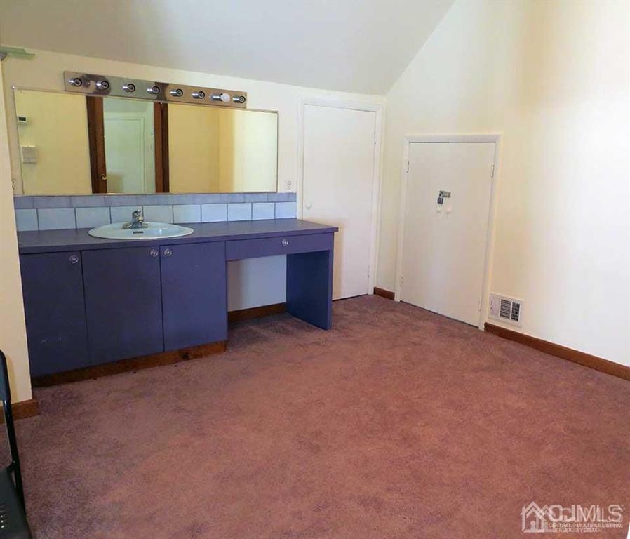 1818 Oak Tree Road Edison, NJ 08820 - Photo 22 of 25 a bathroom with a granite countertop sink and a mirror