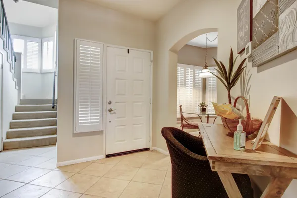 a view of a dining room with furniture and a chandelier