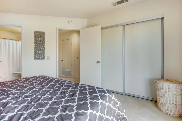 a bedroom with a bed and a cabinets