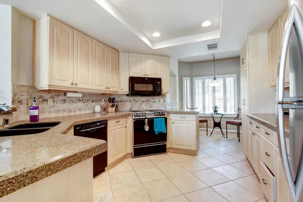 a kitchen with a stove top oven sink and cabinets