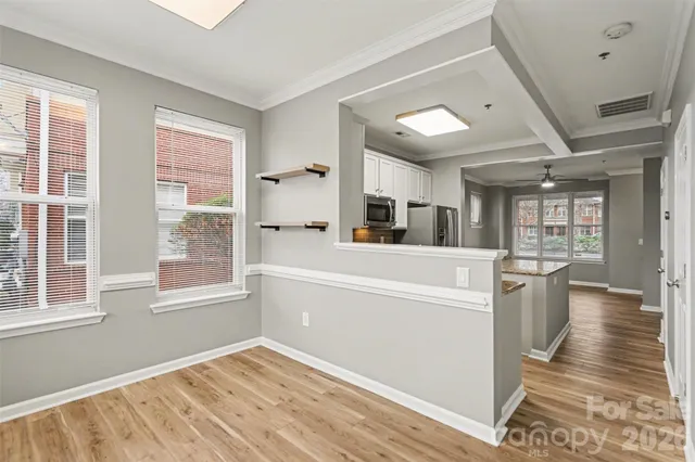 a view of a kitchen with furniture and wooden floor
