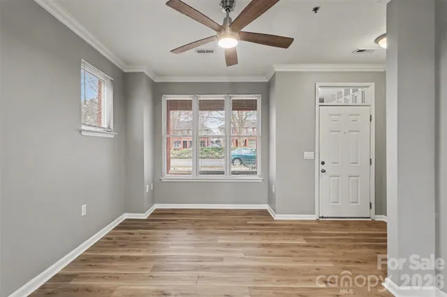 a view of a livingroom with a ceiling fan and window