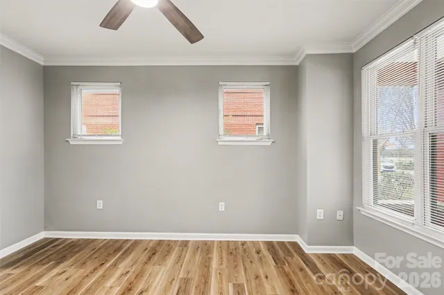 a view of a room with wooden floor and windows