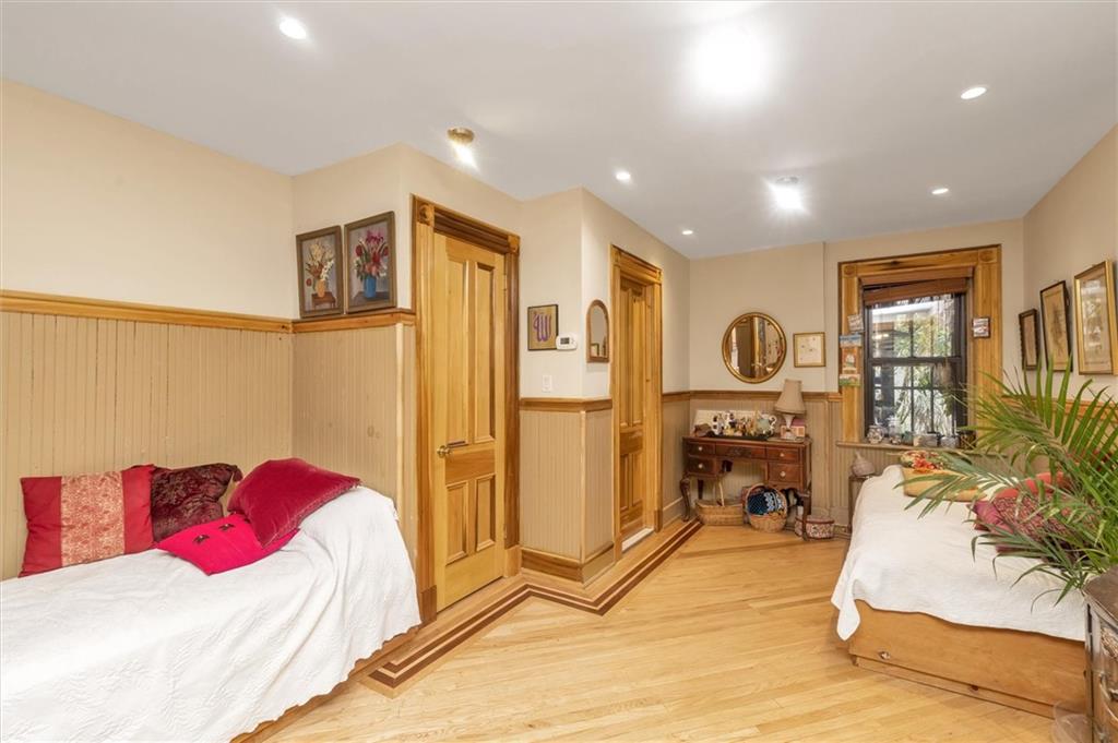 264 Decatur Street Brooklyn, NY 11233 - Photo 18 of 27 a bedroom with a bed and glass windows