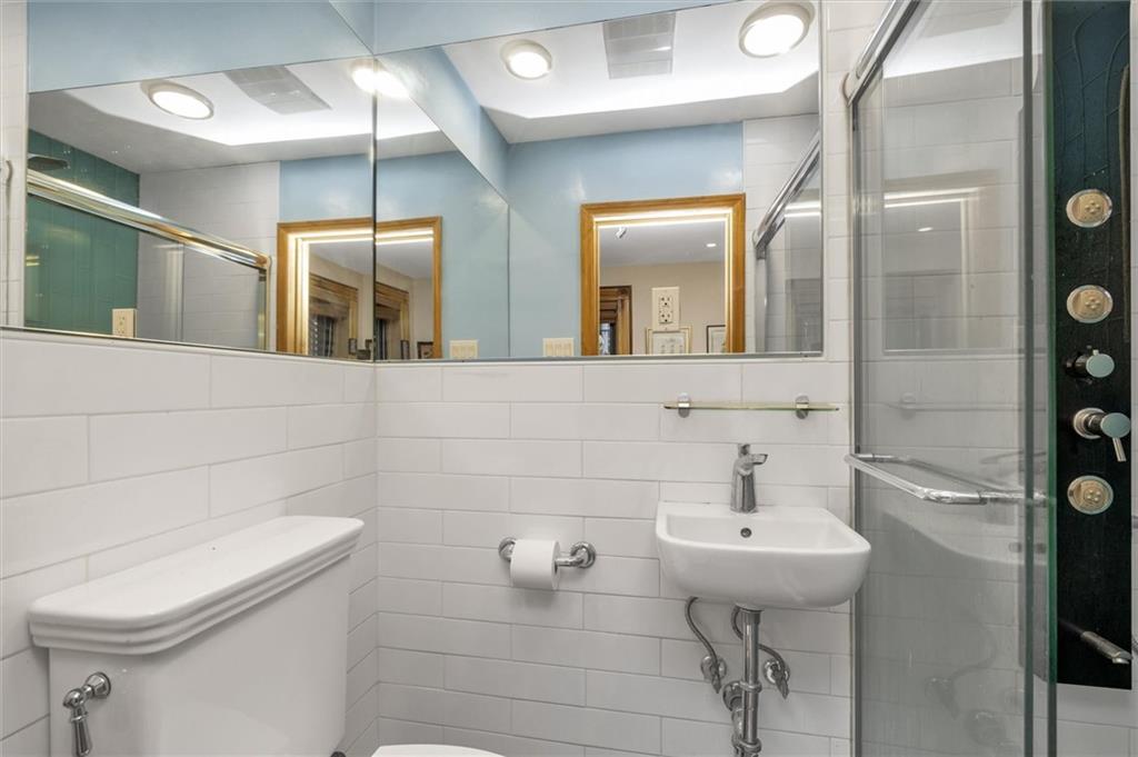 264 Decatur Street Brooklyn, NY 11233 - Photo 19 of 27 a bathroom with a sink a toilet and shower