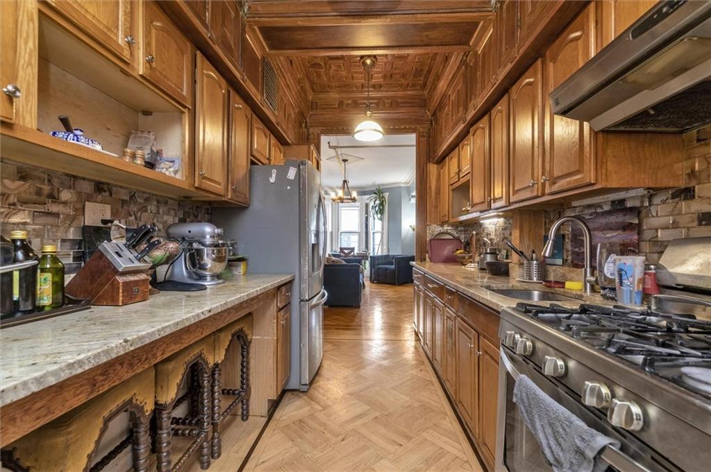 264 Decatur Street Brooklyn, NY 11233 - Photo 21 of 27 a kitchen with stainless steel appliances granite countertop a stove and a sink