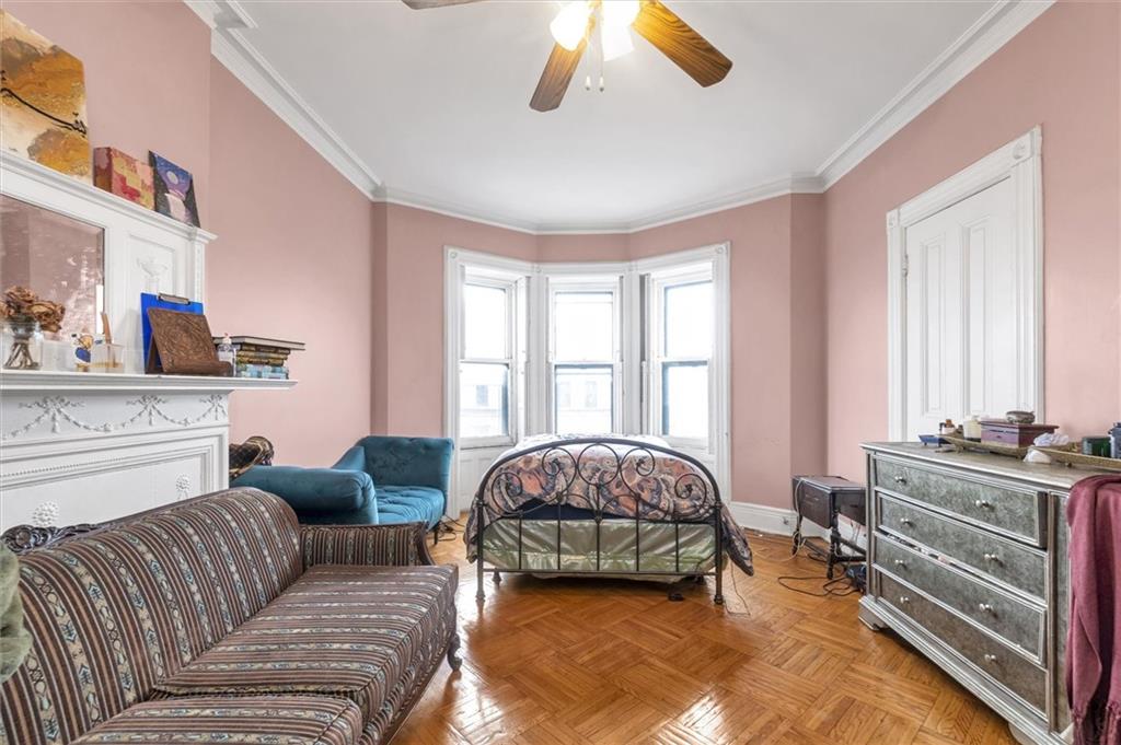 264 Decatur Street Brooklyn, NY 11233 - Photo 24 of 27 a living room with furniture and a window