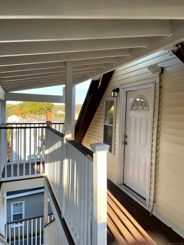 a view of a balcony with wooden floor
