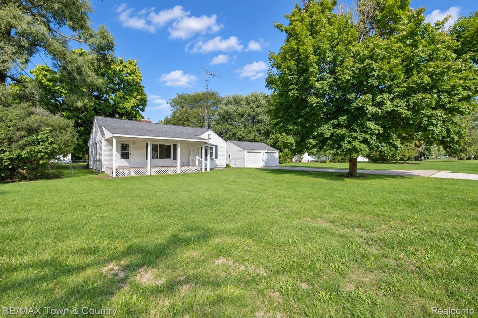 300 Elms Road Flushing, MI 48433 - Photo 1 of 26 Ranch-style residence featuring a covered front porch, white siding, and a gabled roof