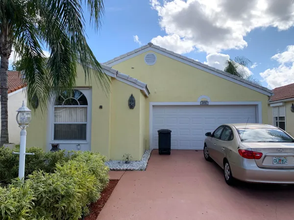 a front view of a house with parking space