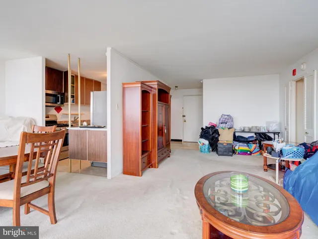 a view of a dining room with furniture and a chandelier