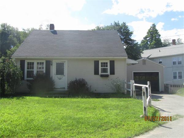 a view of a house with a yard and sitting area