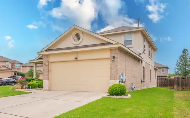 a front view of a house with garden