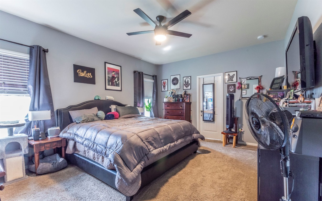 1714 Deodara Drive Cedar Park, TX 78613 - Photo 15 of 37 a bedroom with a bed and a flat screen tv
