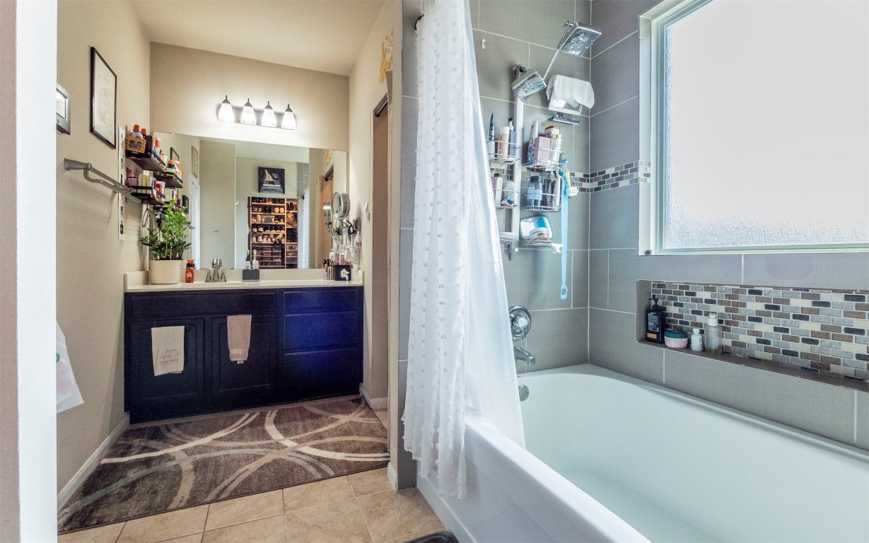 1714 Deodara Drive Cedar Park, TX 78613 - Photo 18 of 37 a bathroom with a bathtub and shower