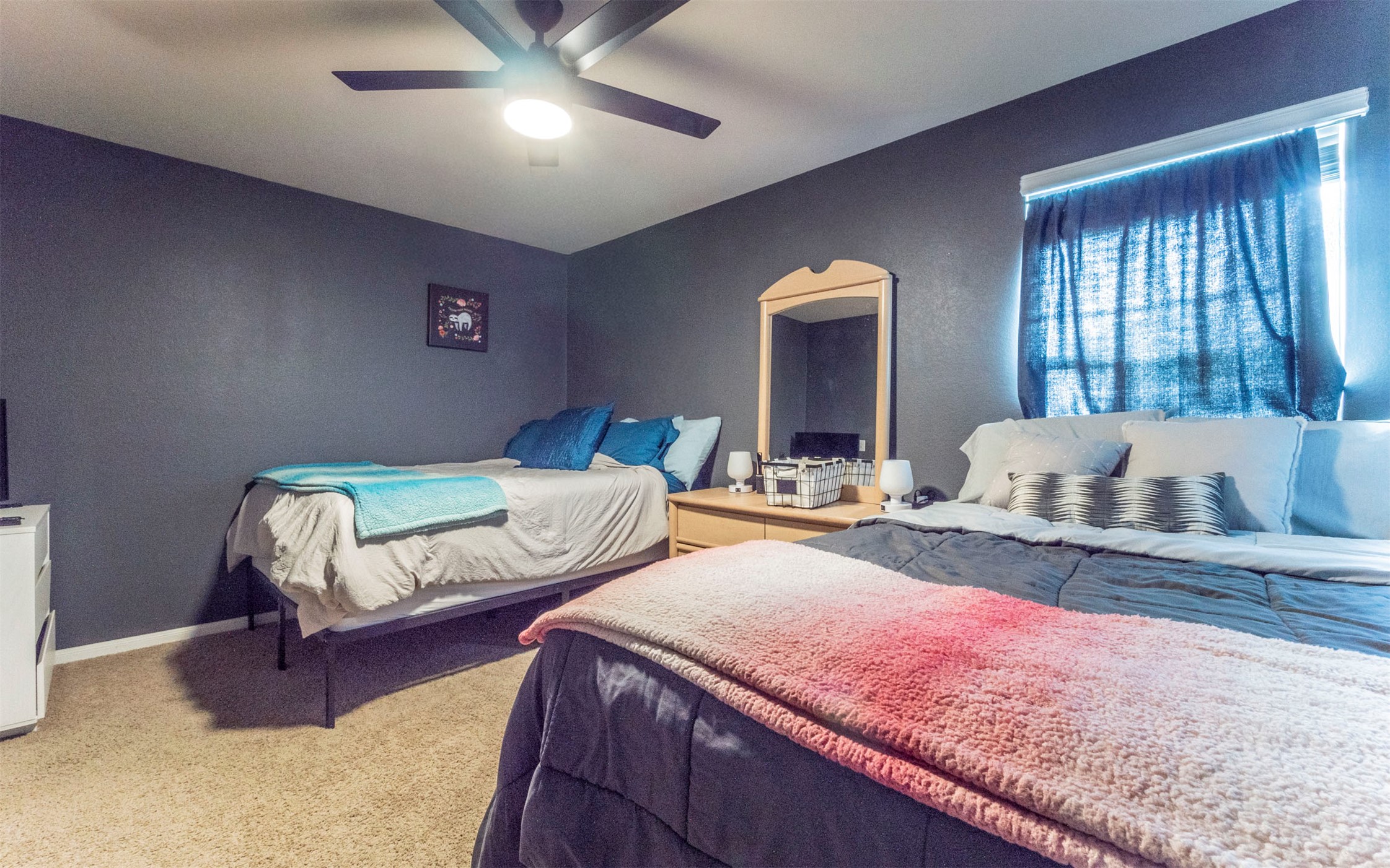 1714 Deodara Drive Cedar Park, TX 78613 - Photo 25 of 37 a spacious bedroom with a bed and a dresser next to a window