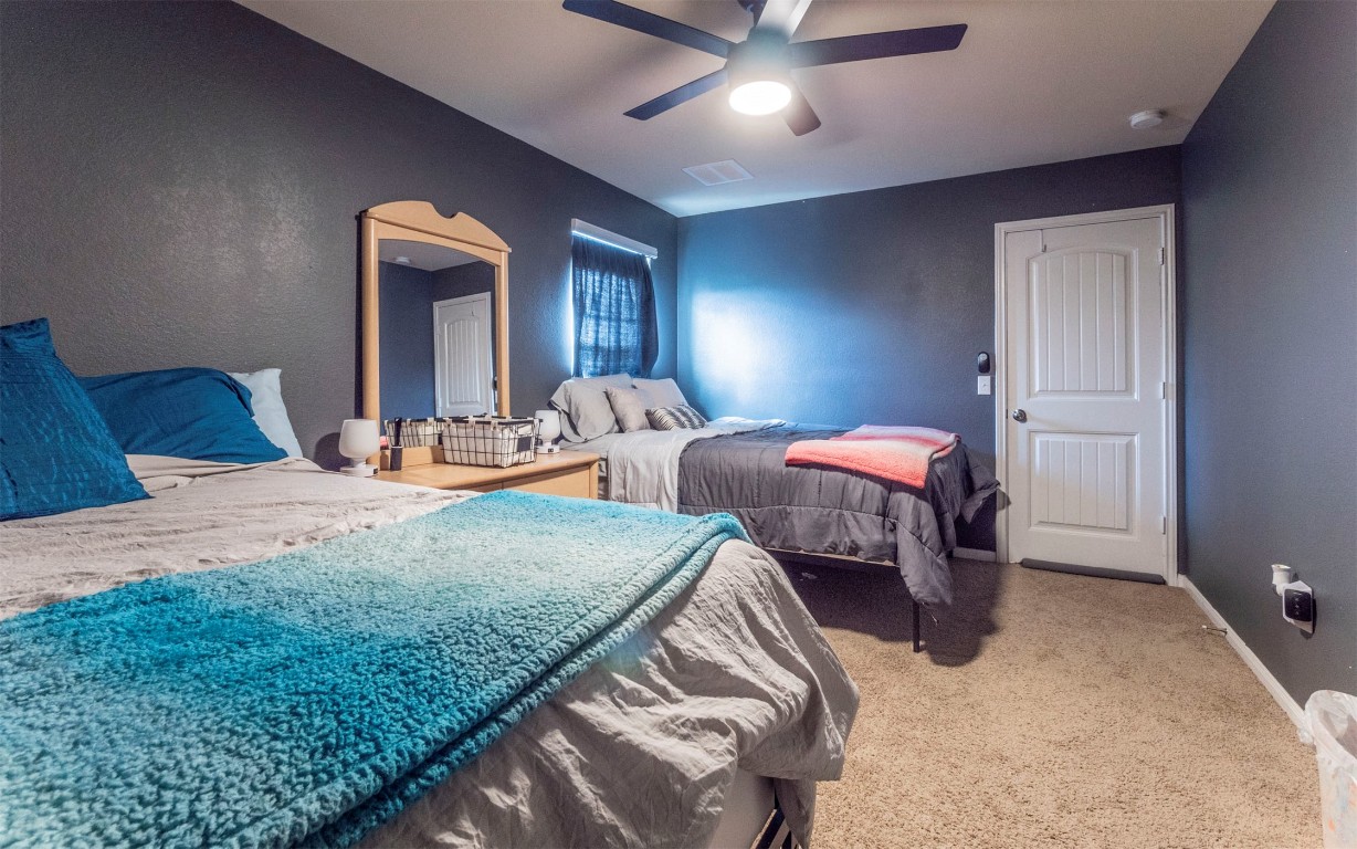 1714 Deodara Drive Cedar Park, TX 78613 - Photo 26 of 37 a bedroom with two beds and painting on the wall