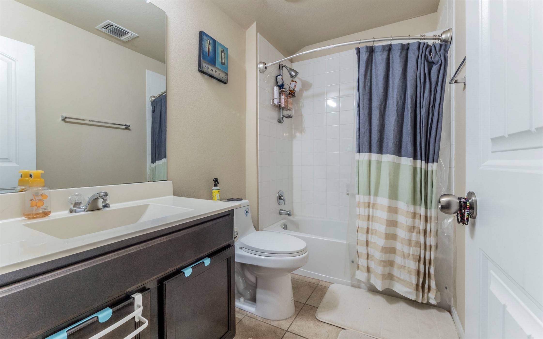 1714 Deodara Drive Cedar Park, TX 78613 - Photo 27 of 37 a bathroom with a sink a toilet and shower curtain