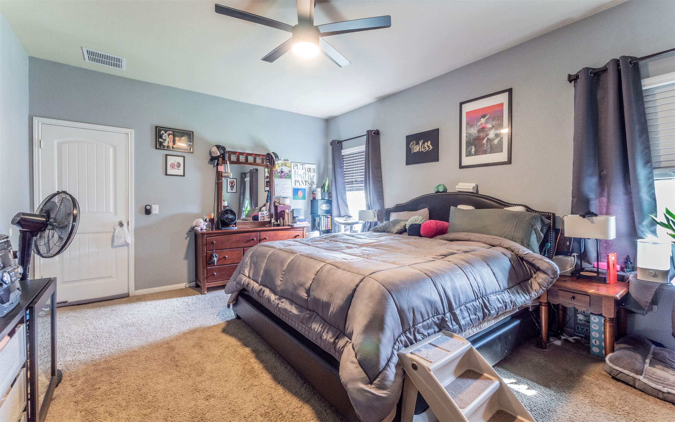 1714 Deodara Drive Cedar Park, TX 78613 - Photo 9 of 37 a bedroom with a bed and a chandelier