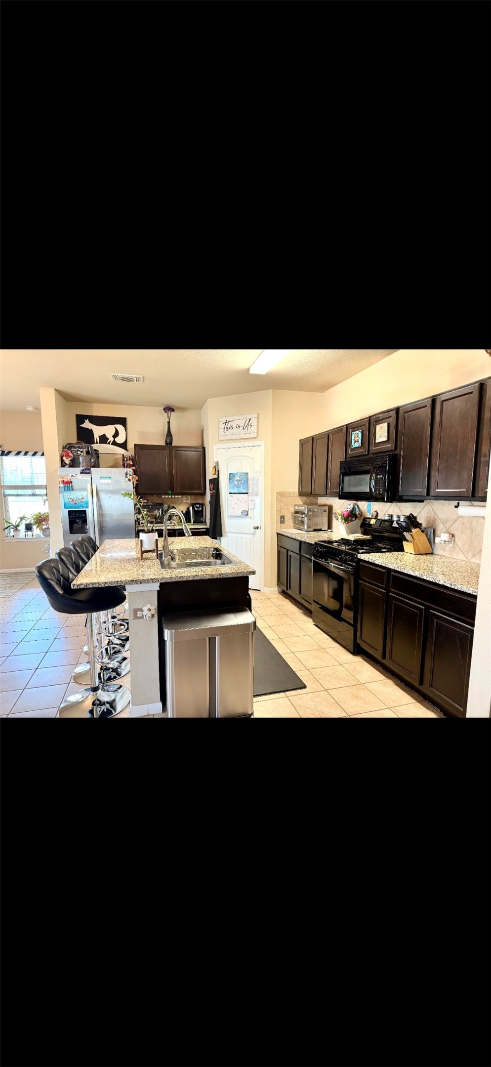 1714 Deodara Drive Cedar Park, TX 78613 - Photo 10 of 37 a kitchen with a stove and a microwave