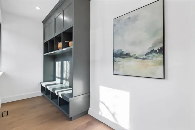 a living room with furniture and a painting on the wall