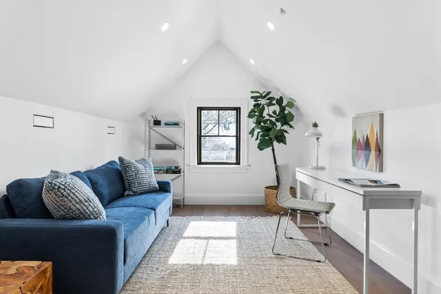 a living room with furniture and a potted plant