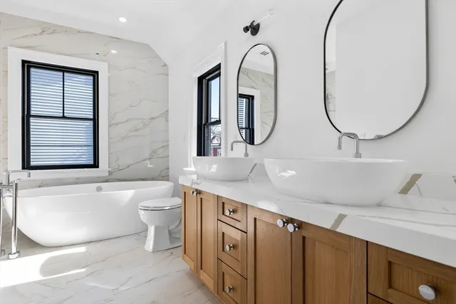 a bathroom with a sink a toilet and a mirror