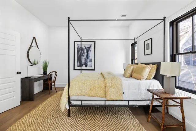 a bedroom with a bed a table and chair