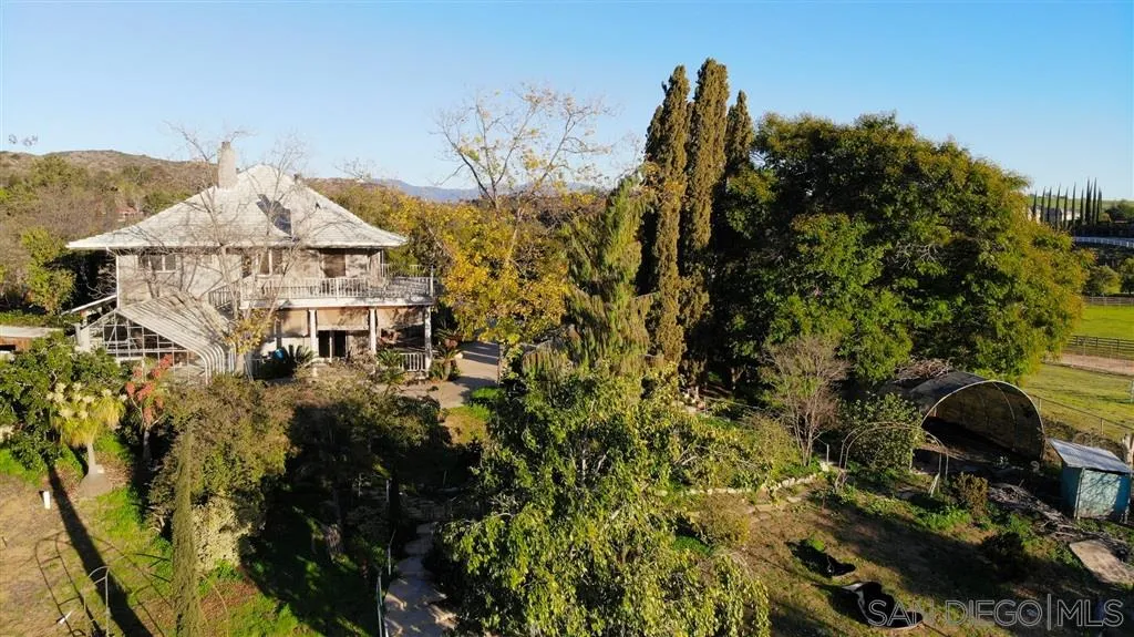 a view of a house with a yard and balcony