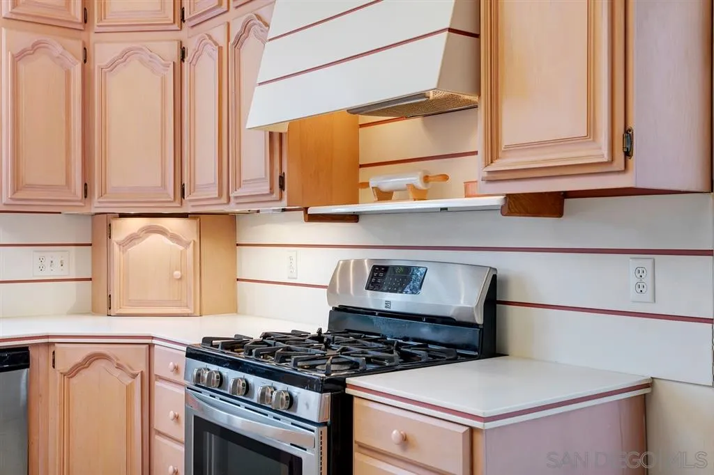 1154 Capra Way Fallbrook, CA 92028 - Photo 11 of 25 a kitchen with stainless steel appliances granite countertop a stove and a microwave