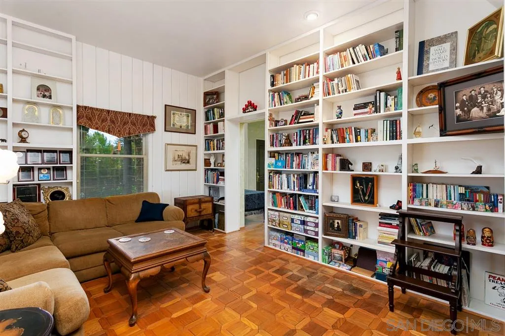 1154 Capra Way Fallbrook, CA 92028 - Photo 13 of 25 a living room with furniture and a book shelf